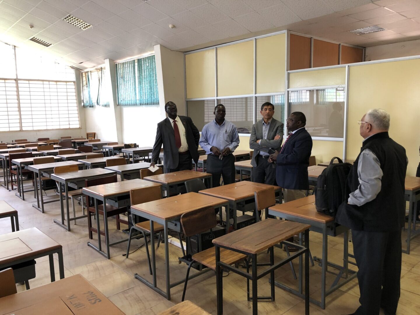 A group of people standing around some tables