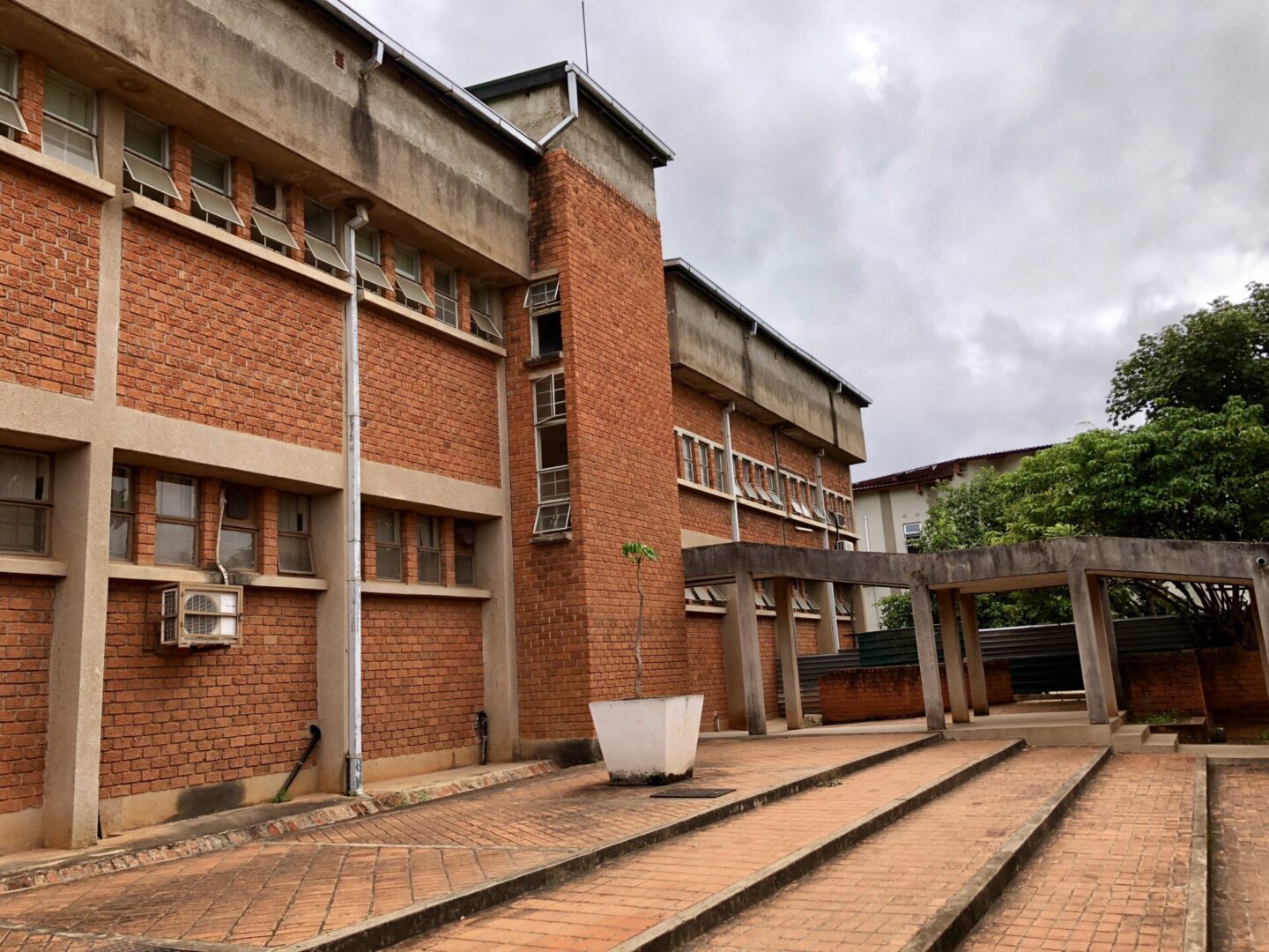 A building with many windows and a brick wall